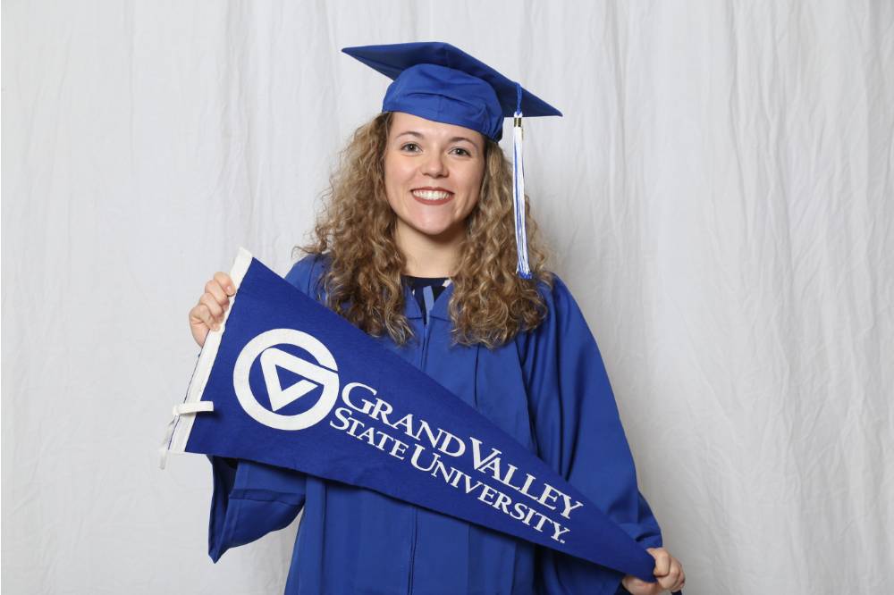 A future alumna poses with a GV flag at GradFest